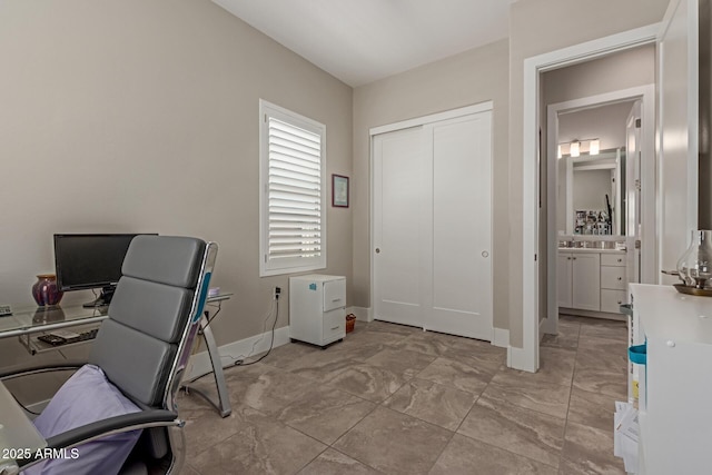 office area with baseboards and a sink