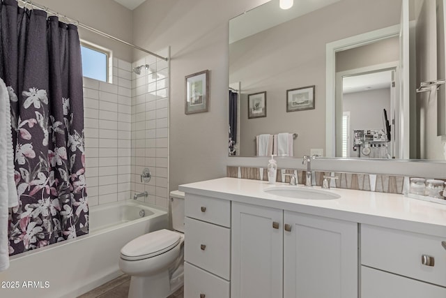 full bath featuring toilet, vanity, and shower / bath combination with curtain