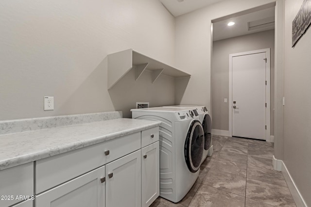 laundry room featuring cabinet space, washing machine and dryer, and baseboards