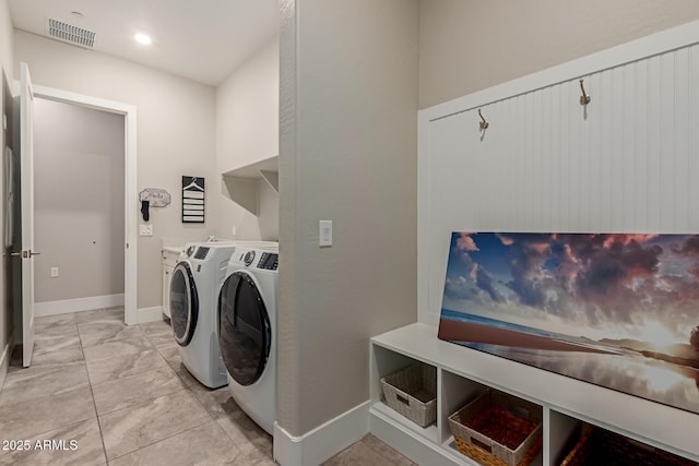 washroom featuring visible vents, marble finish floor, washer and dryer, baseboards, and laundry area