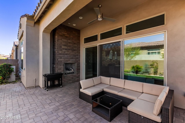 view of patio with an outdoor living space and a ceiling fan