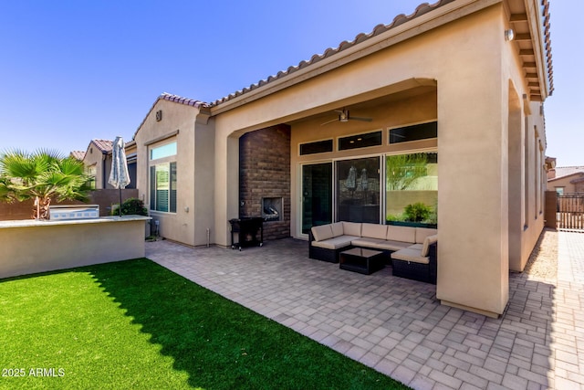 view of patio featuring ceiling fan, outdoor lounge area, and fence