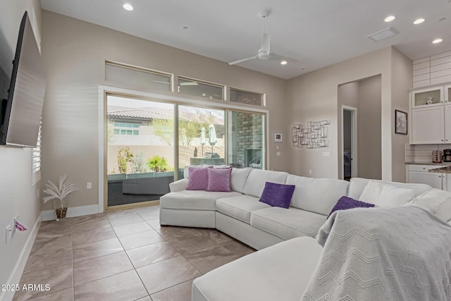 living room with light tile patterned flooring, recessed lighting, baseboards, and ceiling fan