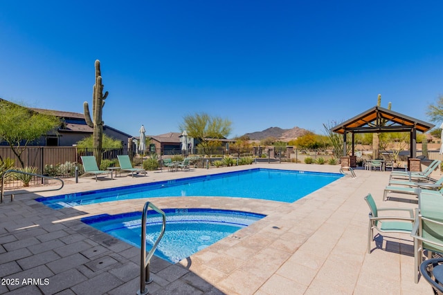 community pool featuring a gazebo, a patio area, and fence