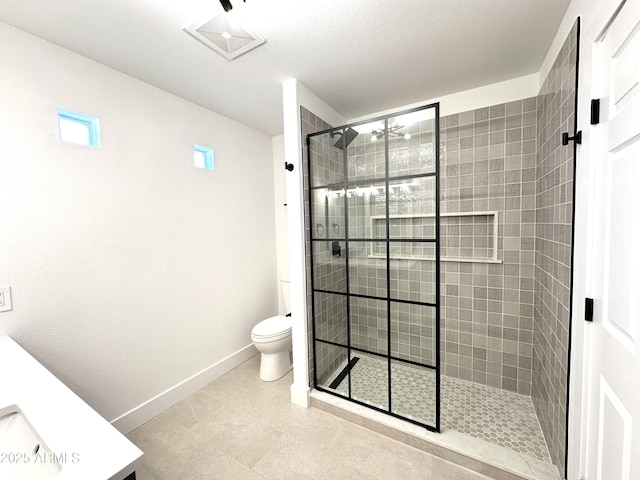 full bathroom with toilet, baseboards, and tiled shower