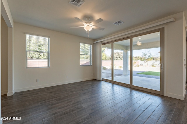 unfurnished room with dark hardwood / wood-style floors, plenty of natural light, and ceiling fan