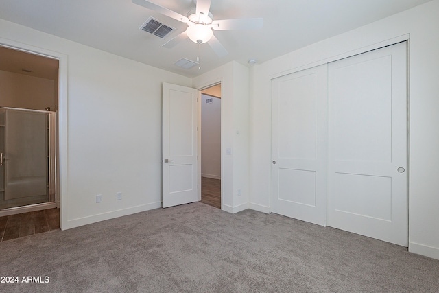 unfurnished bedroom with ceiling fan, a closet, and light carpet