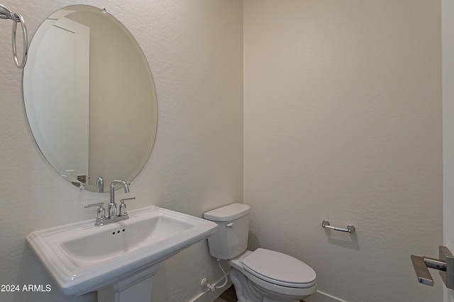 bathroom featuring sink and toilet