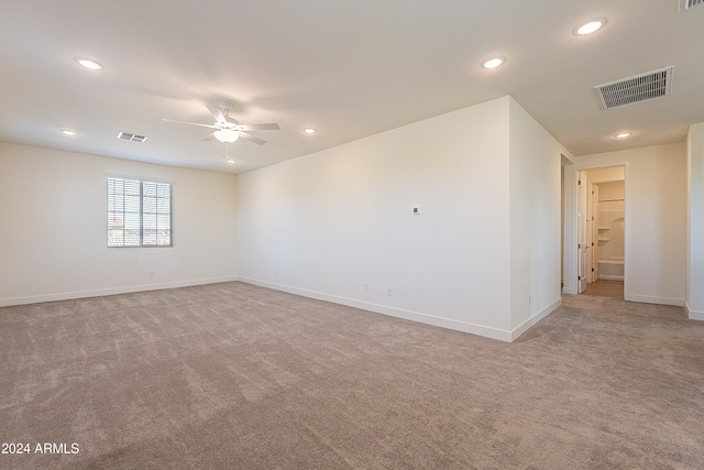 carpeted spare room with ceiling fan