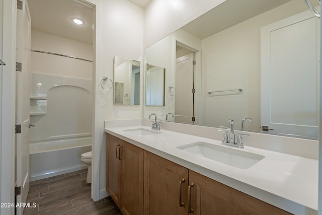 full bathroom with shower / bathing tub combination, vanity, toilet, and wood-type flooring