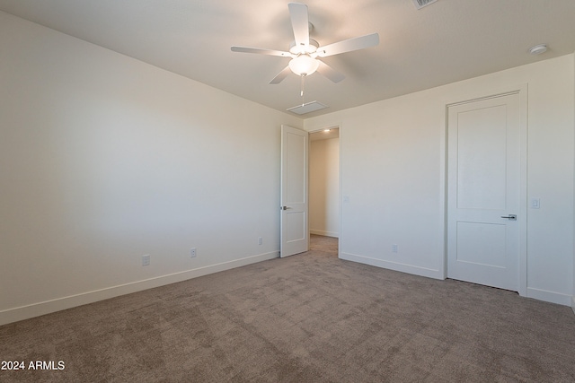 carpeted empty room with ceiling fan