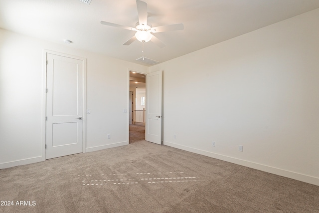 unfurnished bedroom with ceiling fan and light carpet