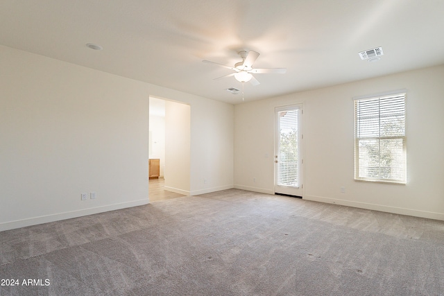 carpeted spare room featuring ceiling fan