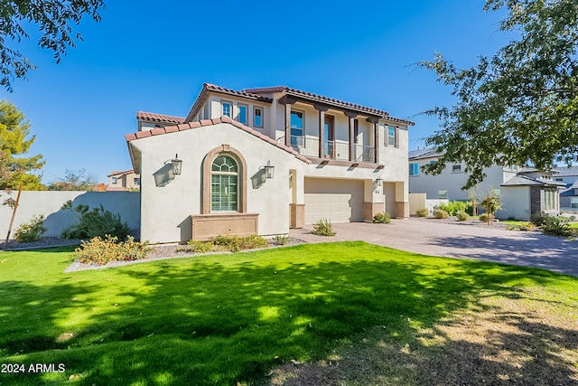 mediterranean / spanish-style house featuring a balcony, a front lawn, and a garage