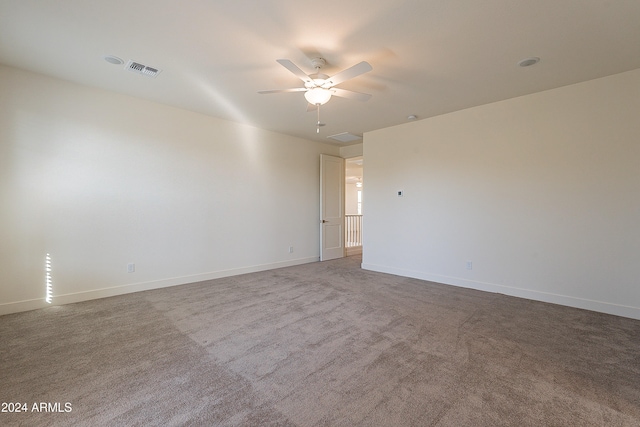 carpeted spare room featuring ceiling fan