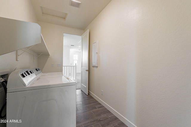 laundry area with dark hardwood / wood-style flooring and separate washer and dryer