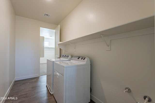 washroom with washing machine and dryer and dark wood-type flooring