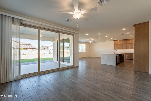 unfurnished living room featuring dark hardwood / wood-style floors, ceiling fan, and sink