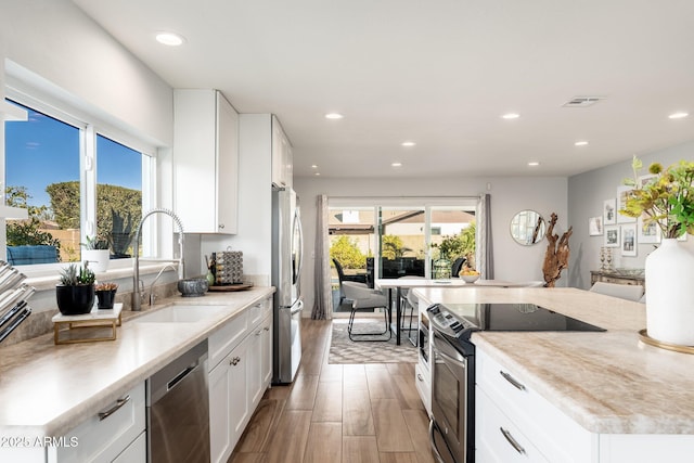 kitchen with white cabinets, sink, and stainless steel appliances