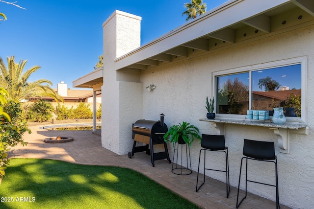 view of patio featuring a bar and grilling area