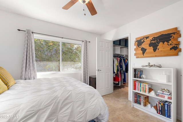 bedroom featuring ceiling fan, a walk in closet, and a closet