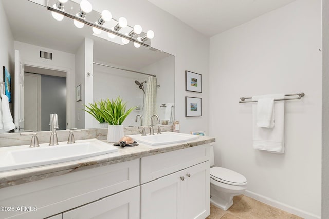 bathroom featuring curtained shower, tile patterned floors, vanity, and toilet