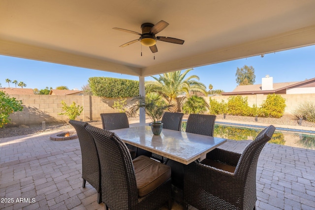 view of patio featuring ceiling fan and an outdoor fire pit