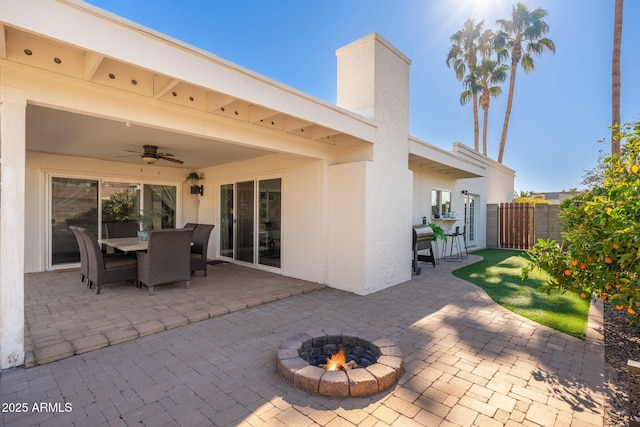 view of patio / terrace featuring ceiling fan and an outdoor fire pit