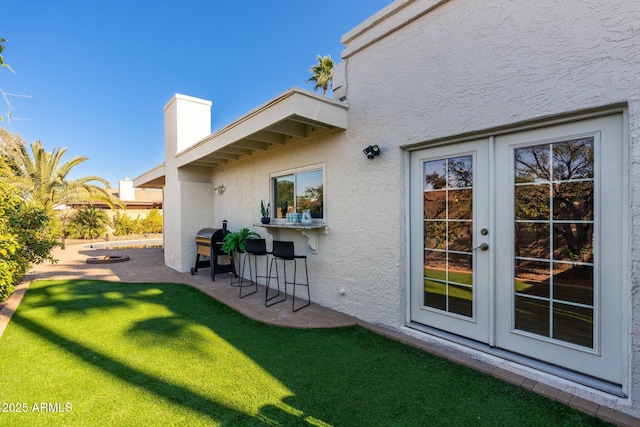 view of yard featuring a bar, french doors, and a patio