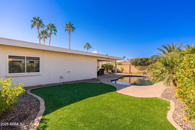 view of yard featuring a fenced in pool and a patio