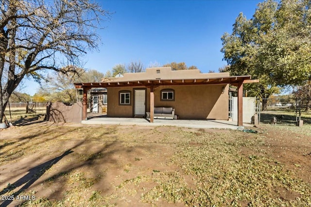 back of property with a patio area