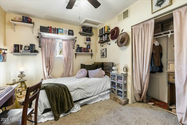 carpeted bedroom featuring ceiling fan and a closet