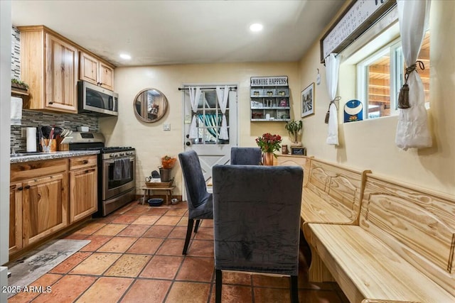 kitchen featuring tasteful backsplash, appliances with stainless steel finishes, and tile patterned floors