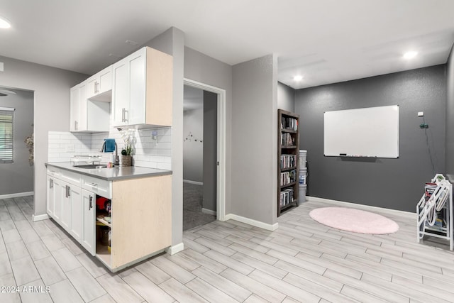 kitchen featuring white cabinetry and tasteful backsplash