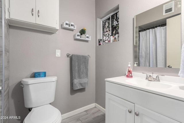 bathroom featuring a shower with curtain, vanity, wood-type flooring, and toilet