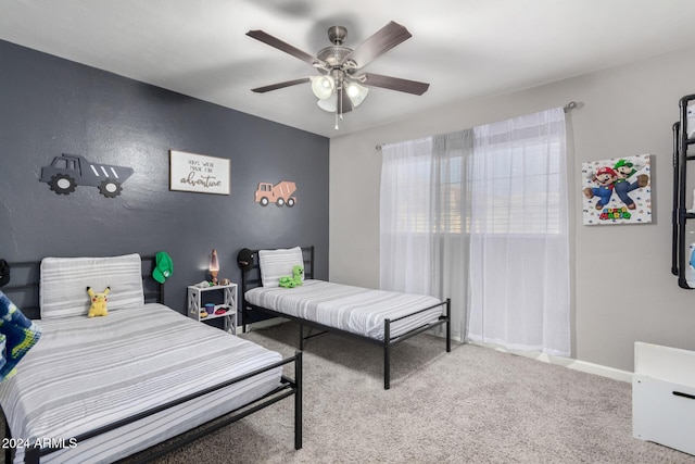 bedroom featuring ceiling fan and carpet