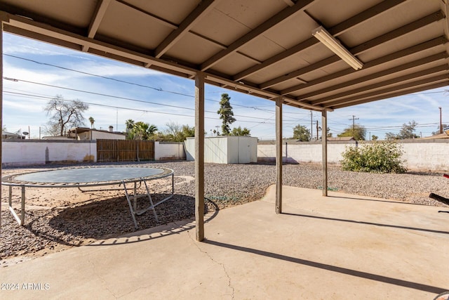 view of patio featuring a shed and a trampoline