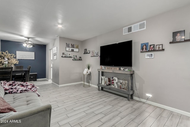 living room featuring ceiling fan and light hardwood / wood-style floors