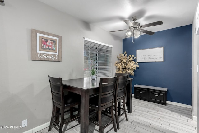 dining room with ceiling fan and light hardwood / wood-style flooring