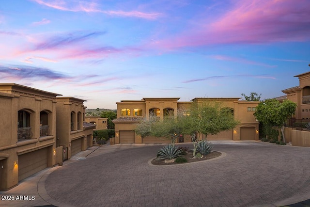 7199 E Ridgeview Pl Unit 221, Carefree, AZ 85377 - view of front facade with a garage, curved driveway, and stucco siding