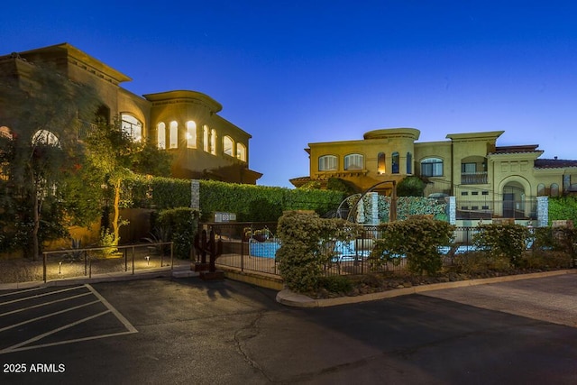 7199 E Ridgeview Pl Unit 221, Carefree, AZ 85377 - view of building exterior with a community pool, uncovered parking, and fence