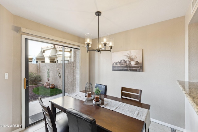 tiled dining space featuring a chandelier