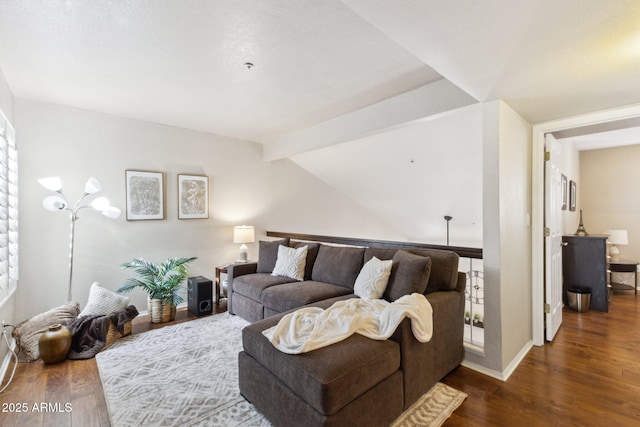 living room featuring vaulted ceiling with beams and dark hardwood / wood-style flooring