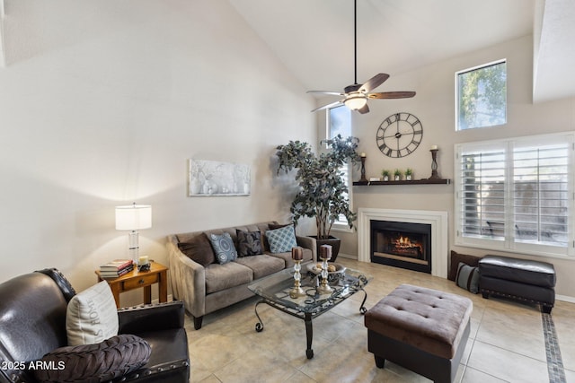 tiled living room with ceiling fan and high vaulted ceiling