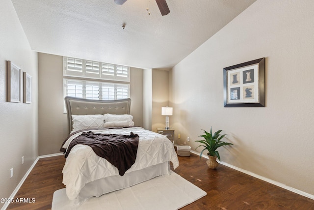 bedroom featuring ceiling fan, dark hardwood / wood-style floors, and a textured ceiling