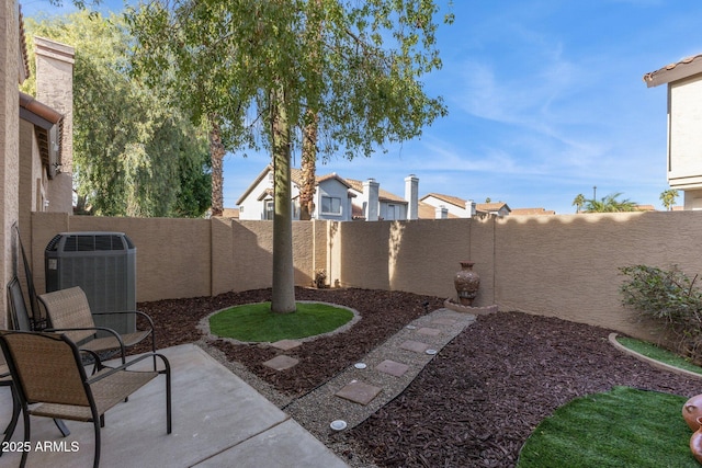 view of yard with cooling unit and a patio area