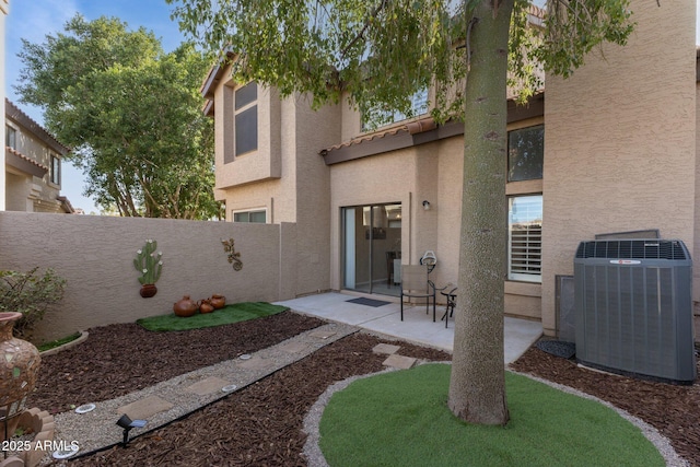 rear view of house with a patio and cooling unit