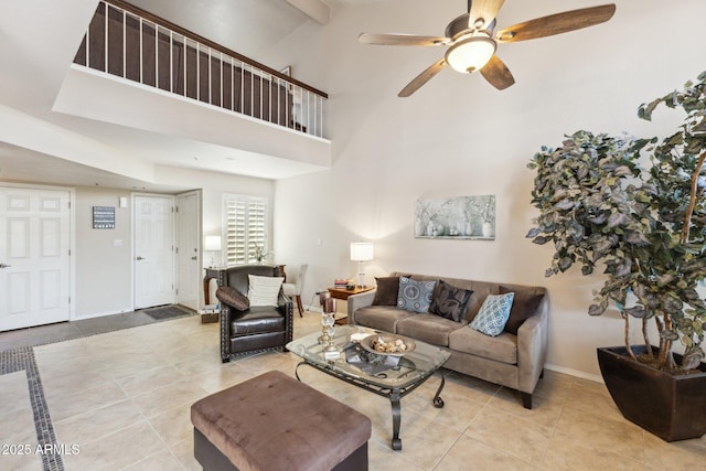 living room featuring beam ceiling, a towering ceiling, light tile patterned floors, and ceiling fan