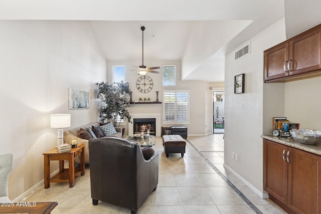 tiled living room featuring vaulted ceiling and ceiling fan