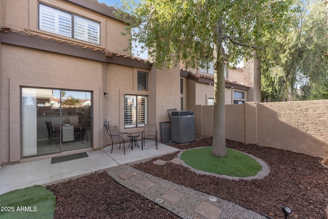 rear view of property featuring cooling unit and a patio